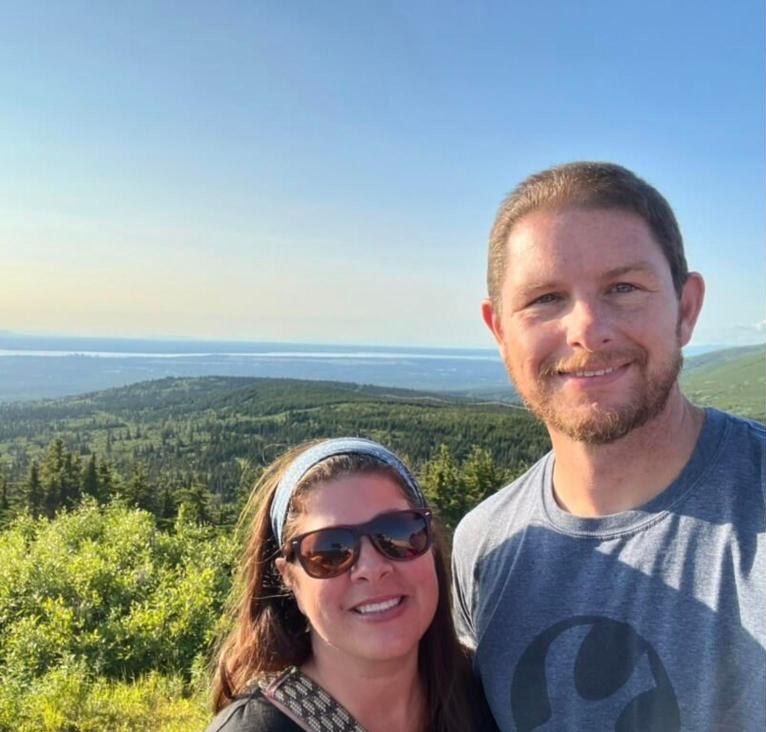 Jay Holland smiling at a mountain overlook